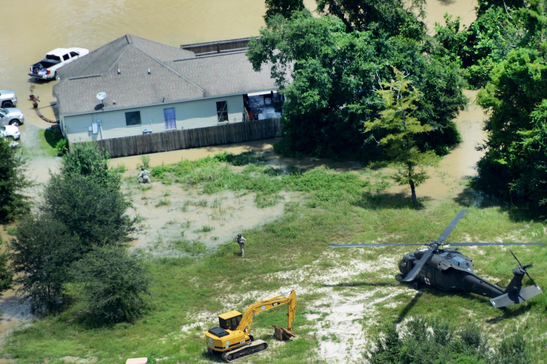 A UH-60 Black Hawk medevac helicopter crew responds to a call for medical assistance near Denham Springs in Livingston Parish, La., Aug. 15, 2016, after more than 30 inches of rainfall caused severe flooding in many portions of southeast Louisiana since  Aug. 12. The helicopter crew is assigned to the Louisiana Army National Guard. Army National Guard photo by 1st Sgt. Paul Meeker