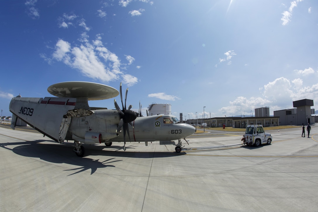 A U.S. Navy E-2C Hawkeye assigned to Carrier Airborne Early Warning Squadron 115, with Carrier Air Wing 5, taxis into hot refueling pits at Marine Corps Air Station Iwakuni, Japan, Aug. 17, 2016. While passing through the air station for aircraft-based training, maintainers inspected and refueled the Hawkeyes before their retrograde back to Naval Air Facility Atusgi. 