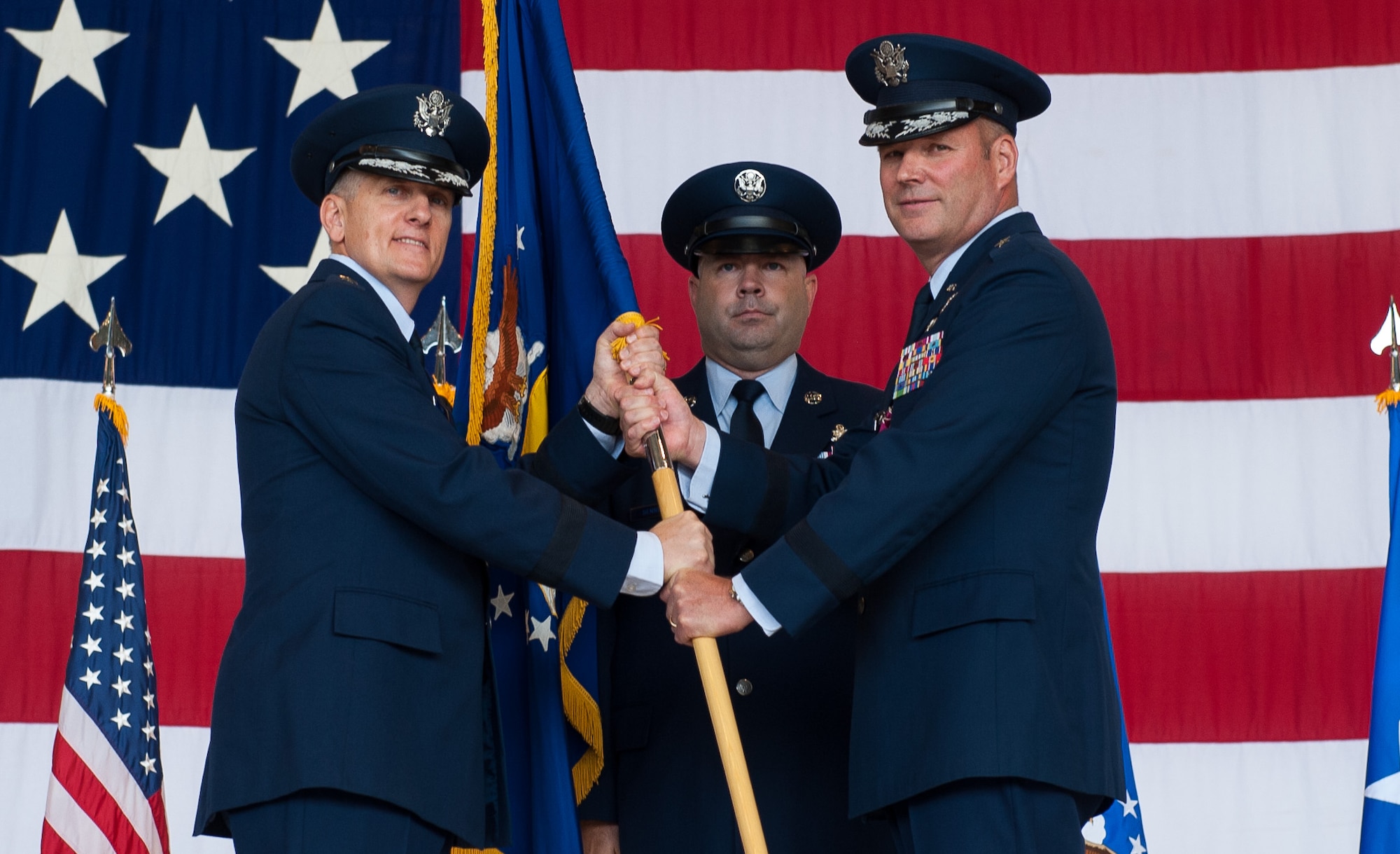 Brig. Gen. Jon T. Thomas, 86th Airlift Wing commander, right, relinquishes the guidon to Lt. Gen. Timothy M. Ray, 3rd Air Force commander, during a change of command ceremony at Ramstein Air Base, Germany, Aug. 17, 2016. Thomas handed over command of the 86th AW to Brig. Gen. Richard G. Moore Jr. (U.S. Air Force photo/ Airman 1st Class Lane Plummer)