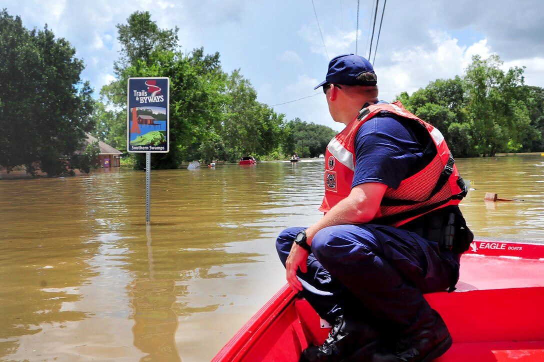 Coast Guard Petty Officer 1st Class Bradley Poen searches for stranded residents in a flooded area of Saint Amant, La., Aug. 16. 2016. Poen is a boatswain's mate assigned to Coast Guard Sector Lower Mississippi River. Coast Guard photo by Petty Officer 1st Class Melissa Leake