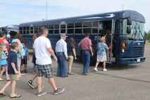 Spectators line up to be shuttled to the flightline at Minot Air Force Base, N.D., for the Northern Neighbors Day Air Show Aug. 13, 2016. Airmen from the 5th Logistics Readiness Squadron transported patrons to and from the entry control point throughout the day. (U.S. Air Force photo/Airman 1st Class Jessica Weissman)