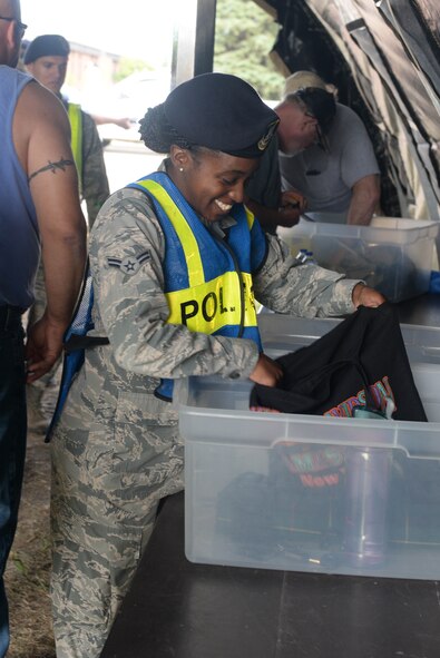 Airman 1st Class Cierra Arthur, an Airman assigned to the 91st Missile Security Forces Squadron, checks a patron’s bag before the Northern Neighbors Day Air Show at Minot Air Force Base, N.D., Aug. 13, 2016. Security Forces Airmen were posted throughout the base to ease traffic flow and ensure security during the event. (U.S. Air Force photo/Airman 1st Class Jessica Weissman)