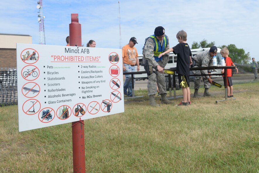 Airmen from the 791st Missile Security Forces Squadron check patrons for prohibited items before the Northern Neighbors Day Air Show at Minot Air Force Base, N.D., Aug. 13, 2016. Approximately 10,000 people came from across the United States and Canada to attend the air show. (U.S. Air Force photo/Airman 1st Class Jessica Weissman)