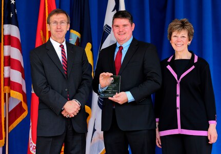 WASHINGTON (June 22, 2016) - Dr. Christopher Weiland, holding the 2015 Dr. Delores M. Etter Top Scientists & Engineers of the Year Award for exceptional scientific and engineering achievement, is flanked by Assistant Secretary of the Navy for Research, Development and Acquisition Sean Stackley and the award's namesake.  Etter, a former Assistant Secretary of the Navy for Research, Development and Acquisition joined Stackley to present the award to recipients at a Pentagon ceremony.  Weiland - a Naval Surface Warfare Center Dahlgren Division engineer - was one of three recipients in the award's Emergent Investigator Category.  He was honored for developing a system that augments naval gunfire capabilities by using unmanned aerial vehicles as additional shipboard sensors. His project eliminates risks in training scenarios and allows U.S. warships to quantitatively train and score gun crews anywhere in the world.