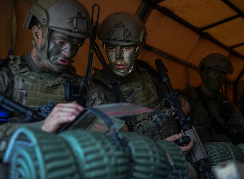 Combat Control School students assigned to the 352nd Battlefield Airmen Training Squadron go over their mission before a tactics field training exercise at Camp Mackall, N.C., Aug. 3, 2016. The FTX is a culmination of tactics learned in the first year of the CCT pipeline; which entails weapons handling, team leader procedures, patrol base operations, troop leading and small unit tactics under fire in one mission. (U.S. Air Force photo by Senior Airman Ryan Conroy)