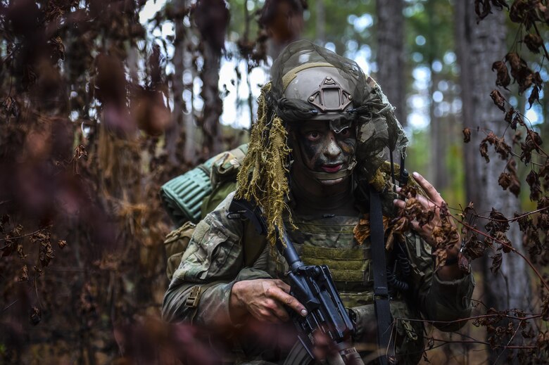 A 342nd Battlefield Airman Training Squadron Combat Control School student scans the woods as rear security for his unit during a tactics field training exercise at Camp Mackall, N.C., Aug. 3, 2016. The 342nd BATS, or Combat Controller School, is the home of a 13-week course that provides initial CCT qualifications. The training includes, small unit tactics, land navigation, communications, assault zones, physical training demolitions, fire support and field operations including parachuting. At the completion of this course, each graduate is awarded the three-skill level, scarlet beret and CCT flash. (U.S. Air Force photo by Senior Airman Ryan Conroy)