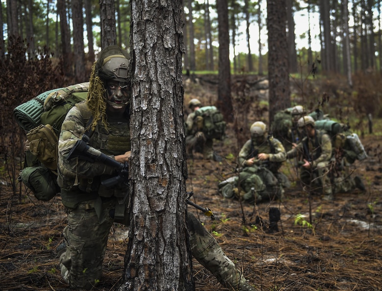 A 352nd Battlefield Airman Training Squadron Combat Control School student scans the woods as rear security for his unit during a tactics field training exercise at Camp Mackall, N.C., Aug. 3, 2016. The FTX is a culmination of tactics learned in the first year of the CCT pipeline; which entails weapons handling, team leader procedures, patrol base operations, troop leading and small unit tactics under fire in one mission. (U.S. Air Force photo by Senior Airman Ryan Conroy)