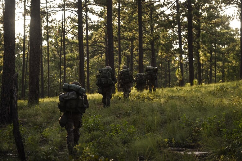 Combat Control School students with the 352nd Battlefield Airman Training Squadron ruck toward their objective point during a tactics field training exercise at Camp Mackall, N.C., Aug. 3, 2016. The FTX is a culmination of tactics learned in the first year of the CCT pipeline; which entails weapons handling, team leader procedures, patrol base operations, troop leading and small unit tactics under fire in one mission. (U.S. Air Force photo by Senior Airman Ryan Conroy)