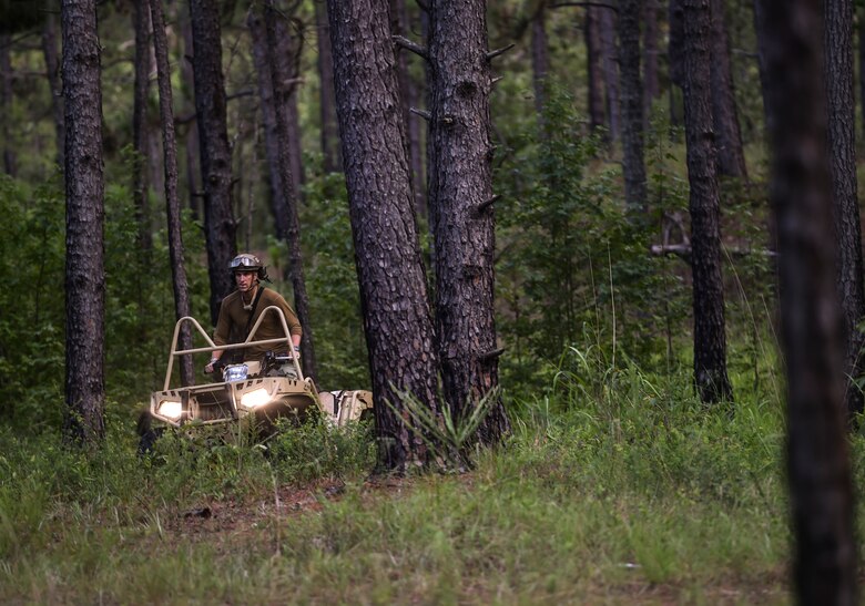 A 352nd Battlefield Airmen Training Squadron Combat Control School instructor rides an ATV in search of CCT students during a field training exercise at Camp Mackall, N.C., Aug. 3, 2016. The 352nd BA TS, or Combat Controller School, is the home of a 13-week course that provides initial CCT qualifications. The training includes, small unit tactics, land navigation, communications, assault zones, physical training demolitions, fire support and field operations including parachuting. At the completion of this course, each graduate is awarded the three-skill level, scarlet beret and CCT flash. (U.S. Air Force photo by Senior Airman Ryan Conroy)