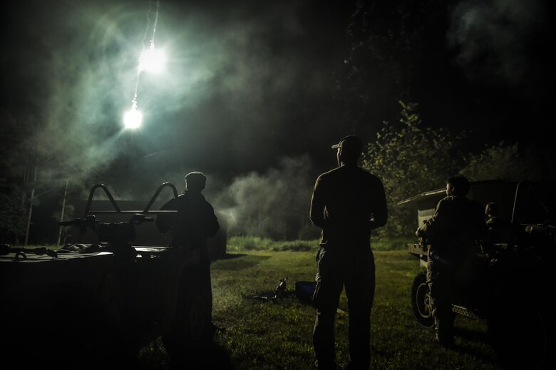 Combat Control School instructors assigned to the 352nd Battlefield Airman Training Squadron, shoot flares in an attempt to draw out CCT students at Camp Mackall, N.C., Aug. 3, 2016. The 352nd BATS, or Combat Control School, is the home of a 13-week course that provides initial CCT qualifications. The training includes, small unit tactics, land navigation, communications, assault zones, physical training demolitions, fire support and field operations including parachuting. At the completion of this course, each graduate is awarded the three-skill level, scarlet beret and CCT flash. (U.S. Air Force photo by Senior Airman Ryan Conroy)