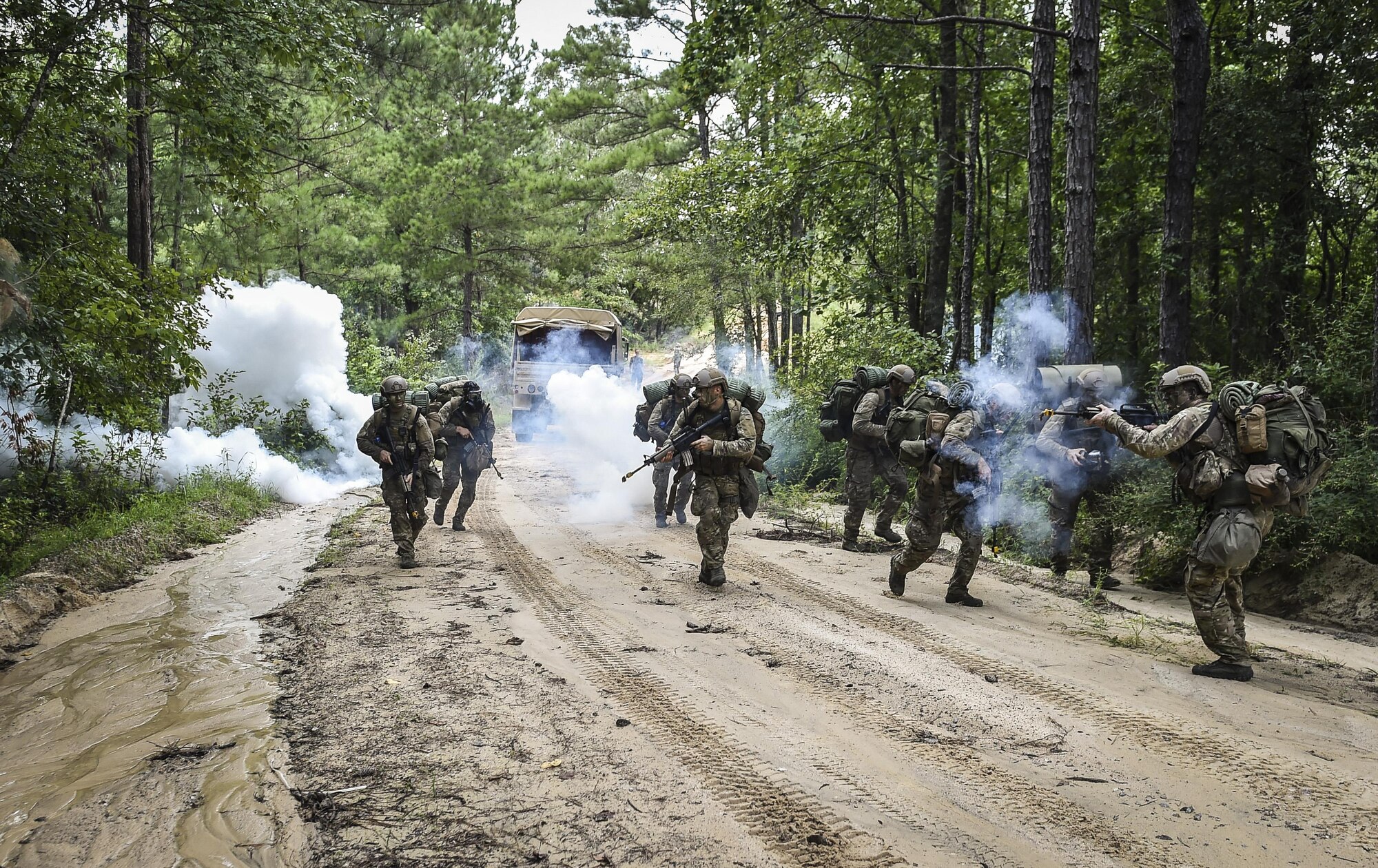 Combat Control School students assigned to the 352nd Battlefield Airmen Training Squadron are ambushed during a tactics field training exercise at Camp Mackall, N.C., Aug. 3, 2016. The FTX is a culmination of tactics learned in the first year of the CCT pipeline; which entails weapons handling, team leader procedures, patrol base operations, troop leading and small unit tactics under fire in one mission. (U.S. Air Force photo by Senior Airman Ryan Conroy)