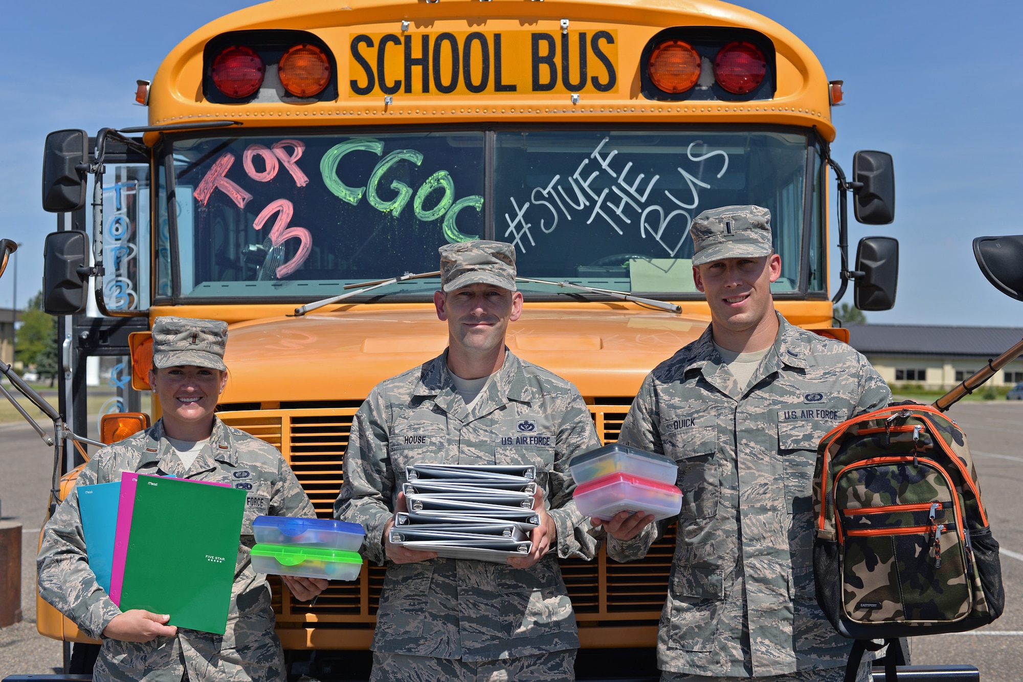 2nd Lt. Teresa Doskey, 341st Contracting Squadron commodities flight commander, left, Master Sgt. Jeffery House, 341st Security Forces Squadron first sergeant, center, and 1st Lt. Aaron Quick, 341st CONS officer in charge of base infrastructure, pose for a photo Aug. 15, 2016, at Malmstrom Air Force Base, Mont. Doskey and Quick are part of the Company Grade Officers’ Council and House is a representative of the Top 3, the two groups hosting the ‘Stuff the Bus’ donation drive. (U.S. Air Force photo/Airman 1st Class Daniel Brosam)