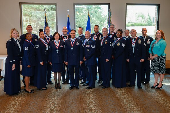Col. DeAnna Burt, 50th Space Wing commander, and Chief Master Sgt. John Bentivegna, 50 SW command Chief Master Sergeant, (second from right) gather for a photo with newly inducted senior NCOs and part of the instructor team from the Senior NCO Professional Enhancement Course during the senior NCO induction ceremony at Peterson Air Force Base, Colorado, Friday, Aug. 12, 2016.  The week-long course helps senior NCOs adapt to their new roles in the Air Force. (U.S. Air Force photo/Christopher DeWitt)