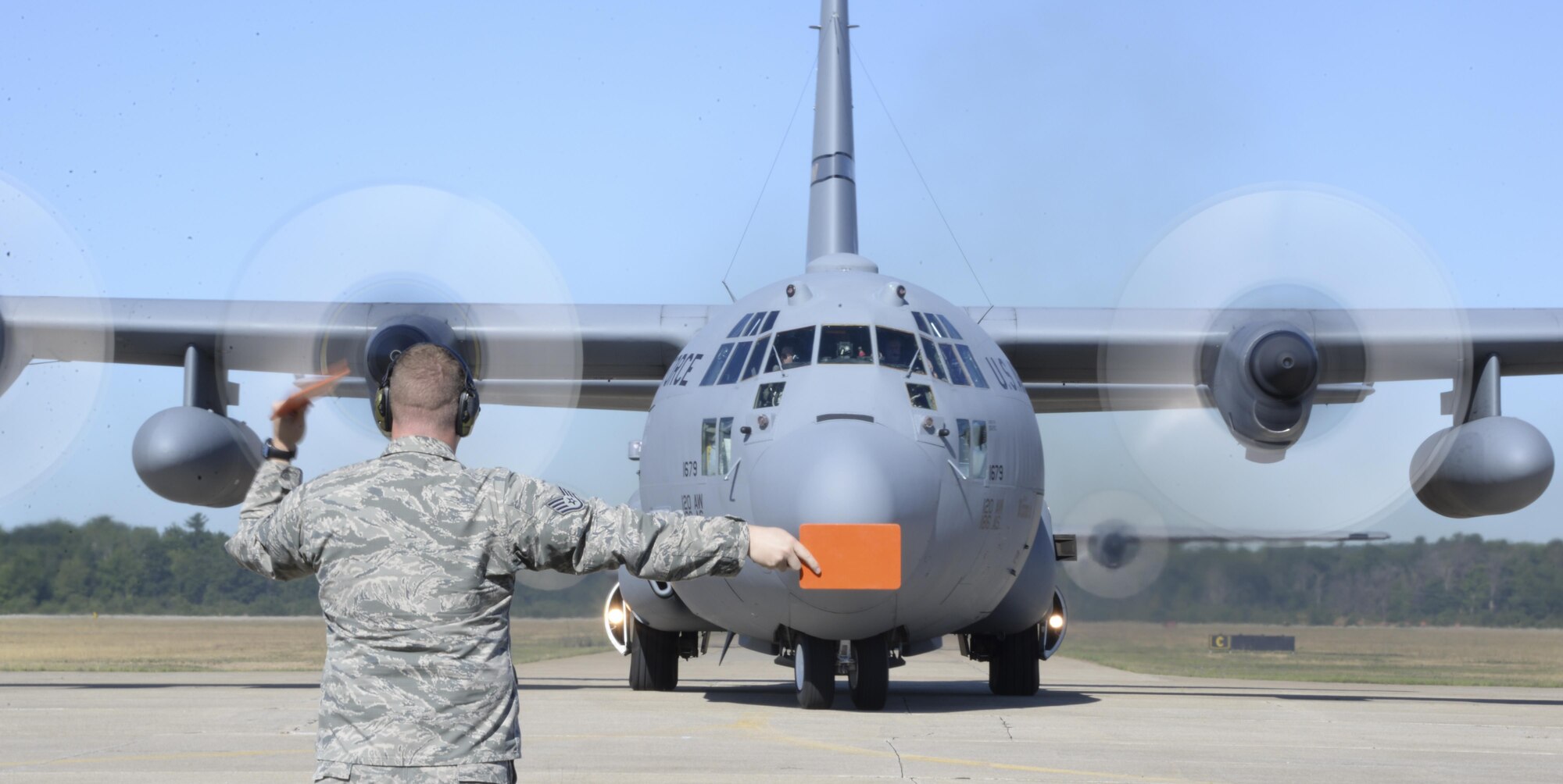 Staff Sgt. Michael Pike, 921st Contingency Response Squadron aero maintenance craftsman, marshals a C-130 Hercules during  Exercise Northern Strike at Grayling Army Airfield, Michigan, Aug. 8, 2016. Exercise Northern Strike is a large-scale exercise coordinated by the Michigan Army National Guard and features Army, Marines and Air Force working together for total force integration. (U.S. Air Force photo by Senior Airman Amber Carter)