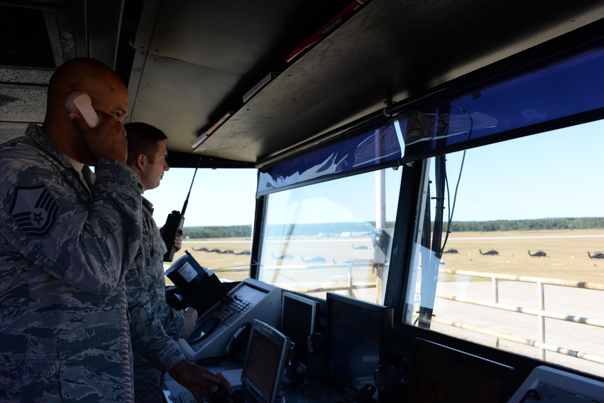 Master Sgt. Greylynn Carr and Master Sgt. Bradley Rich, 821st Contingency Response Squadron air traffic control craftsmen, watch the skies and the flightline from the tower at Grayling Army Airfield, Michigan, Aug. 8, 2016. Both Carr and Rich are stationed at Travis Air Force Base, California, and were in Michigan as part of Exercise Northern Strike. Exercise Northern Strike is a large-scale exercise coordinated by the Michigan Army National Guard and features Army, Marines and Air Force working together for total force integration. (U.S. Air Force photo by Senior Airman Amber Carter)