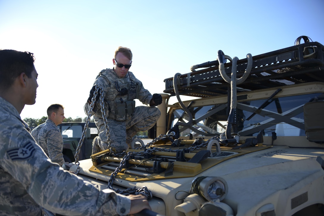 Staff Sgt. Steven Ramos, 921st Contingency Response Squadron airfield management student, and Staff Sgt. William Harden, 921st CRS ramp coordination instructor, prepare a HUMVEE to be lifted by a CH-47 Chinook at Alpena Combat Readiness Training Center, Michigan, during Exercise Northern Strike, Aug. 9 , 2016. With more than 5,000 participants from Michigan, Illinois, Latvia, Canada and Poland, among others, Exercise Northern Strike combined air and ground capabilities into a single exercise. The size and quality of the training area allowed for the large-scale exercise to take place. (U.S. Air Force photo by Senior Airman Amber Carter)