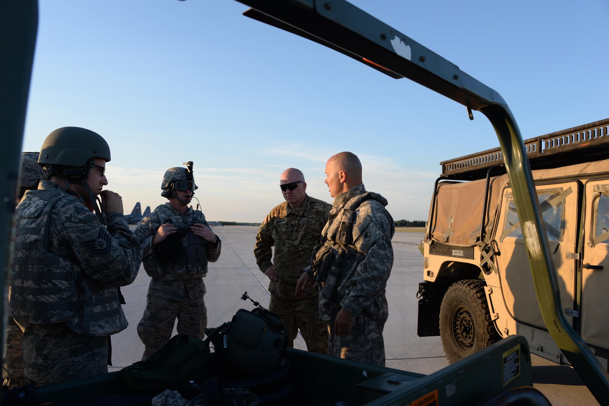 U.S. Army Chief Warrant Officer 3 Eric Tupa, Company B 3-238 General Support Aviation Battalion CH-47 Chinook pilot, right, briefs Airmen from the 821st Contingency Response Group at Alpena Combat Readiness Training Center, Michigan, during Exercise Northern Strike, Aug. 9, 2016. The 821st CRG Airmen were told how to properly attach a HUMVEE to the underside of a Chinook. (U.S. Air Force photo by Senior Airman Amber Carter) 