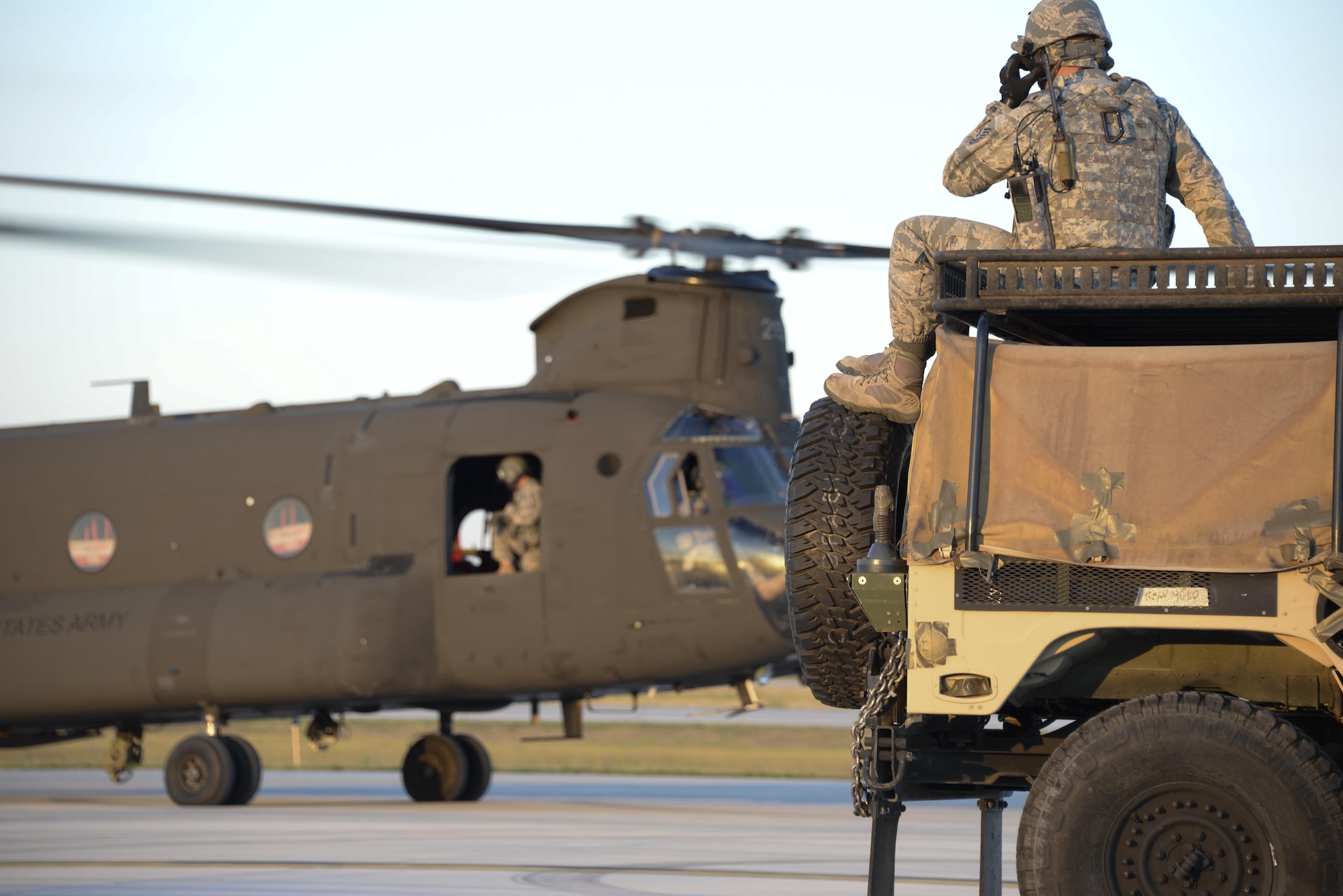 Staff Sgt. William Harden, 921st Contingency Response Squadron ramp coordination instructor, waits for the U.S. Army CH-47 Chinook to takeoff during Exercise Northern Strike at Alpena Combat Readiness Training Center, Michigan, Aug. 9, 2016. Harden, stationed at Travis Air Force Base, California, participated in a sling load exercise to practice attaching a HUMVEE to a Chinook. (U.S. Air Force photo by Senior Airman Amber Carter)