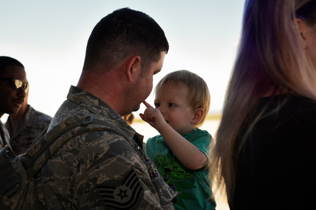 An Airman from the 4th Space Control Squadron holds his son on the flightline at Peterson Air Force Base, Colo., Aug. 13, 2016. His unit just returned from deployment and his family had been waiting for hours to meet him. (U.S. Air Force photo by Senior Airmen Rose Gudex)