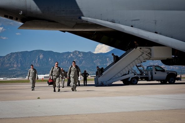 Airmen from the 4th Space Control Squadron disembark a C-5 Galaxy to greet their families at Peterson Air Force Base, Colo., Aug. 13, 2016. The Airmen were deployed overseas and rushed to greet waiting family members. (U.S. Air Force photo by Senior Airman Rose Gudex)