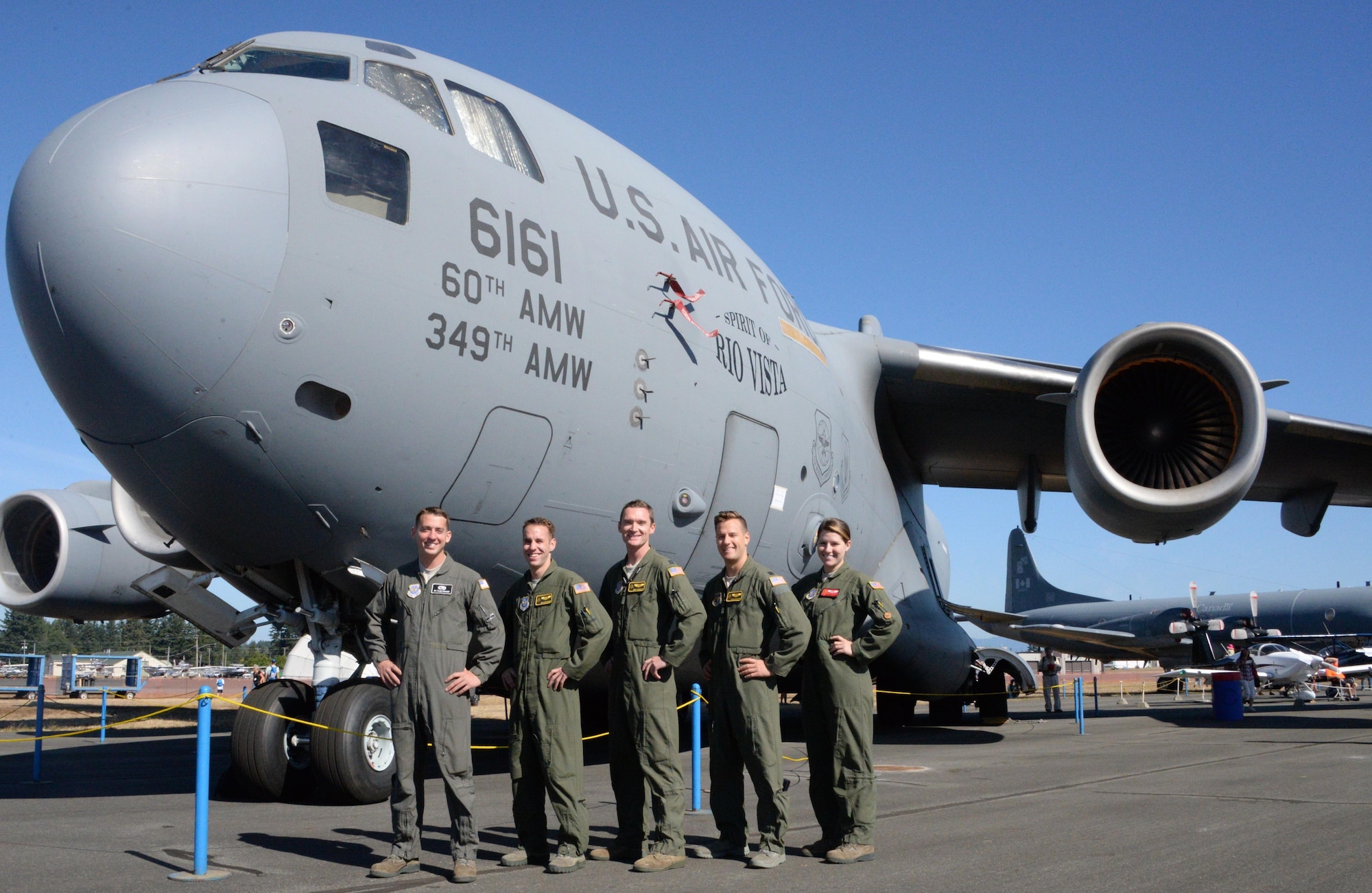 (From left to right) Senior Airman Caleb Schneider, Airman 1st Class Austin Whisler, Capt. Eric Rieboldt, Capt. Kyle McAlpin, and Senior Airman Jacquelyn Justice pose for a picture in front of a C-17 Globemaster III during the Abbotsford International Airshow, in Abbotsford, British Columbia, Aug. 14, 2016.  The aircrew, from the 21st Airlift Squadron hosted a static display, sharing the C-17 Globemaster IIIs role in supporting its mission-set of rapid global mobility. (U.S. Air Force photo by 2nd Lt. Geneva Croxton)