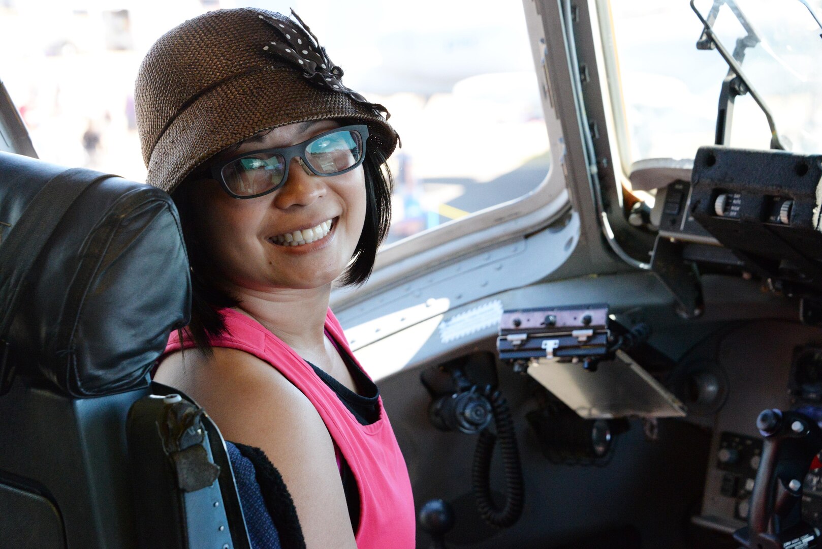 A guest poses for a photo in the pilots seat of a C-17 Globemaster III assigned to Travis Air Force Base, Calif., during the Abbotsford International Airshow, in Abbotsford, British Columbia, Aug. 14, 2016.  The C-17 Globemaster III, flown by members of the 21st Airlift Squadron, participated in the airshow as a static display, sharing the C-17 Globemaster IIIs role in supporting its mission-set of rapid global mobility. (U.S. Air Force photo by 2nd Lt. Geneva Croxton)