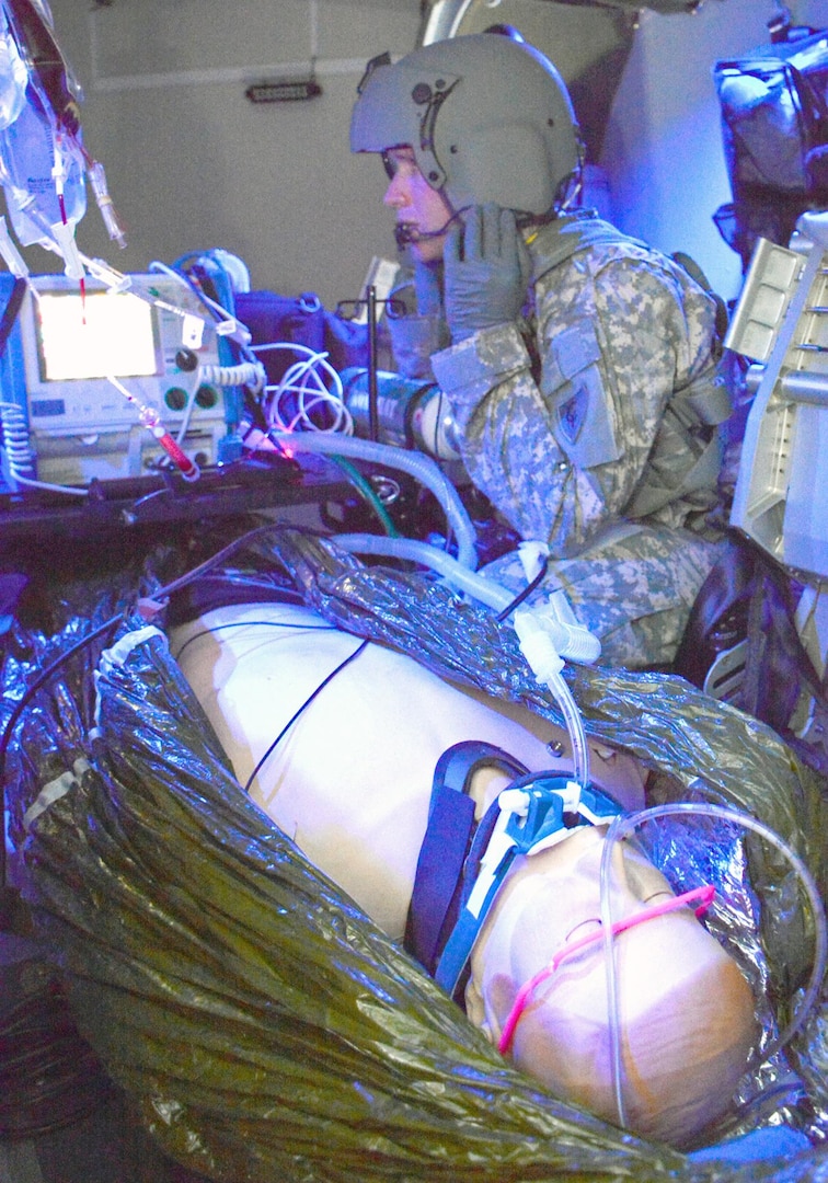 Sgt. Marty Anderson, Det. 1, Company C, 3rd Battalion, 238th Aviation Regiment, Michigan National Guard, monitors the status of a medical patient simulator while onboard a UH-60 Blackhawk trainer. Taught at the U.S. Army Medical Department Center and School at Fort Sam Houston, the flight paramedic course trains 68Ws medical enlisted personnel with the knowledge and skills required to conduct advanced critical care pre-medical evacuation treatment, loading and unloading patients in MEDEVAC aircraft, and stabilize and treat patients in flight. 