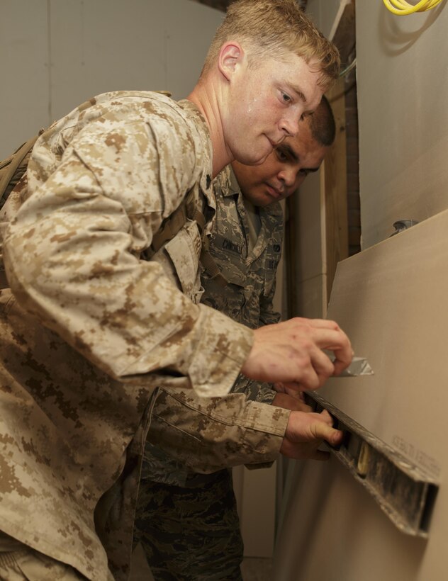 Cpl.  Thomas A. Trinosky Jr., a combat engineer with Engineer Services Company, Combat Logistics Battalion 25, and Senior Airman Michael Chinchilla, an engineering assistant with 482nd Civil Engineering Squadron, Air Force Reserve, prepare to cut a piece of drywall during Innovative Readiness Training Dry Tortugas at Dry Tortugas National Park, Fla., Aug. 15, 2016. IRT Dry Tortugas is an Air Force Reserve-led project to provide construction services at the request of the National Park Service. During this year’s iteration, the Marines and Airmen worked together to renovate the crew quarters of Fort Jefferson in Dry Tortugas. (U.S. Marine Corps photo by Sgt. Ian Leones/Released)