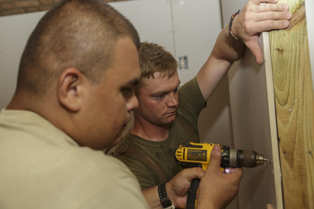 Cpl.  Thomas A. Trinosky Jr., a combat engineer with Engineer Services Company, Combat Logistics Battalion 25, and Senior Airman Michael Chinchilla, an engineering assistant with 482nd Civil Engineering Squadron, Air Force Reserve, secure a piece of drywall during Innovative Readiness Training Dry Tortugas at Dry Tortugas National Park, Fla., Aug. 15, 2016. IRT Dry Tortugas is an Air Force Reserve-led project to provide construction services at the request of the National Park Service. During this year’s iteration, the Marines and Airmen worked together to renovate the crew quarters of Fort Jefferson in Dry Tortugas. (U.S. Marine Corps photo by Sgt. Ian Leones/Released)