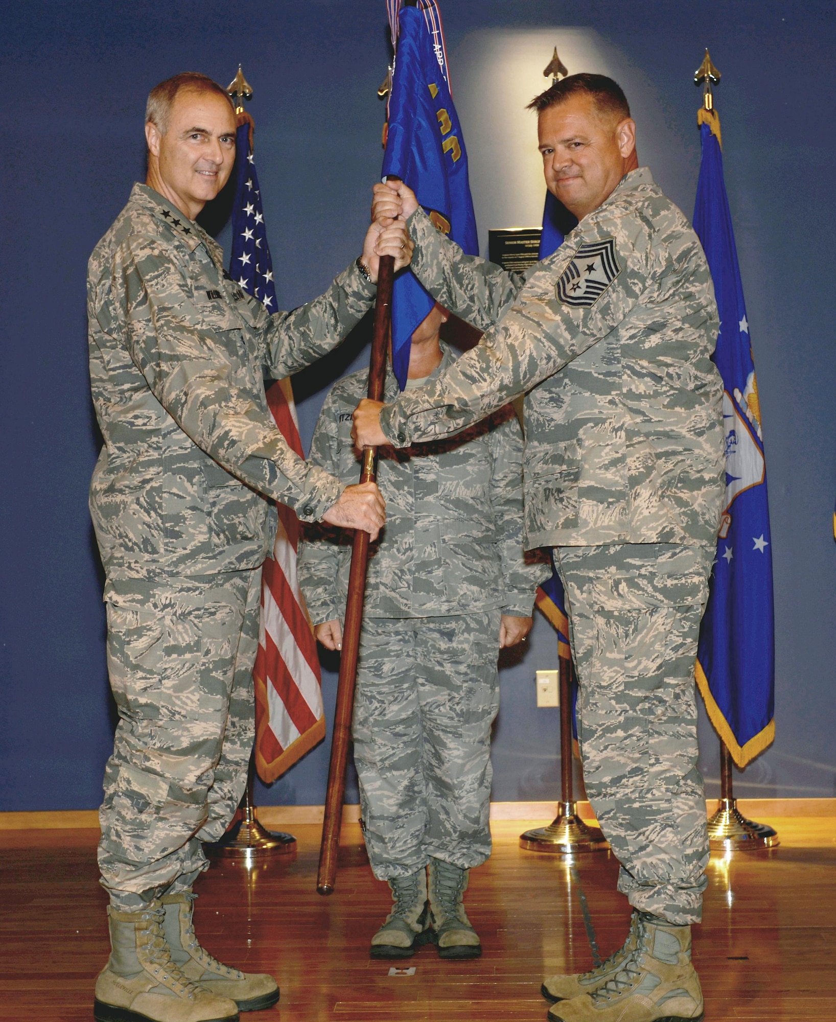 U.S. Air Force Lt. Gen. Scott Williams, Continental U.S. North American Aerospace Defense Command Region and 1st Air Force (Air Forces Northern) Commander, passes the 1AF guidon to Chief Master Sgt. Richard King during the change of authority ceremony at Tyndall Air Force Base, Fla., Aug. 15. King assumed the position from interim Command Chief, Chief Master Sgt. Tiffiney Kellum. (U.S. Air Force photo by Maj. Kat Andrews)