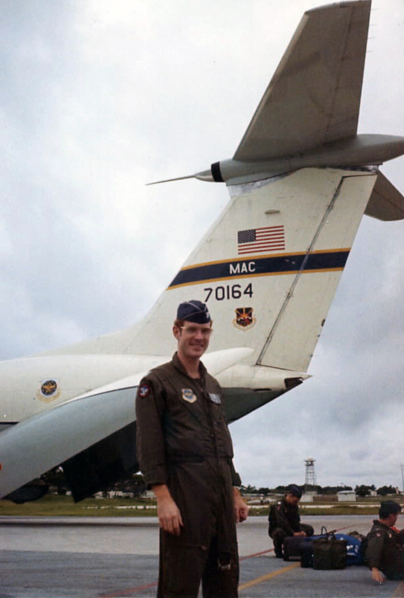 Capt. Robert Allen, 62nd Airlift Wing historian, poses for a photo in front of a C-141A aircraft in 1974 at Kadena Air Force Base, Japan. Allen flew as a navigator in the 4th Airlift Squadron from 1973-1976. (Courtesy photo)  