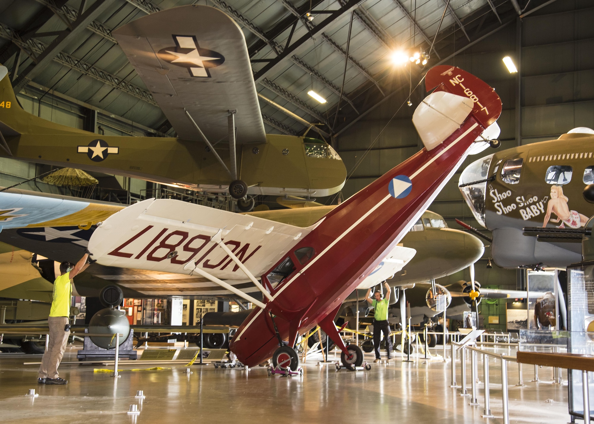 DAYTON, Ohio -- Restoration crews move the Fairchild Model 24-C8F (UC-61J) into the WWII Gallery at the National Museum of the United States Air Force. (U.S. Air Force photo by Ken LaRock)