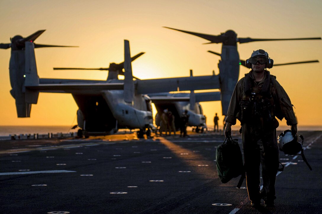 Marine Corps Lance Cpl. Jonathan Salinas exits the USS Makin Island flight deck following flight operations in San Diego, Aug. 12, 2016. The Makin Island is conducting a Composite Training Unit Exercise with Amphibious Squadron Five and the 11th Marine Expeditionary Unit to prepare for deployment. Salinas is assigned to Marine Medium Tiltrotor Squadron 163. Navy photo by Seaman Clark Lane