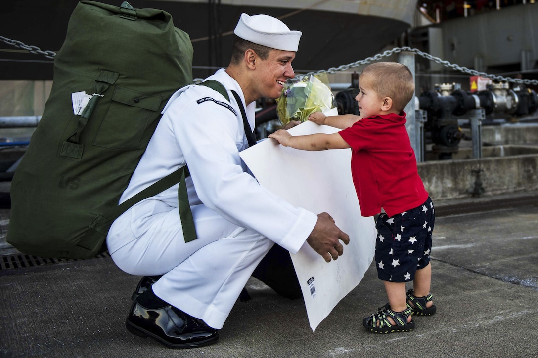 A sailor reunites with his family after returning home from a seven-month deployment aboard USS John C. Stennis in Bremerton, Washington, Aug. 14, 2016. Providing a combat-ready force to protect collective maritime interests, the Stennis returned from a regularly scheduled Western Pacific deployment. Navy photo by Seaman Cole C. Pielop