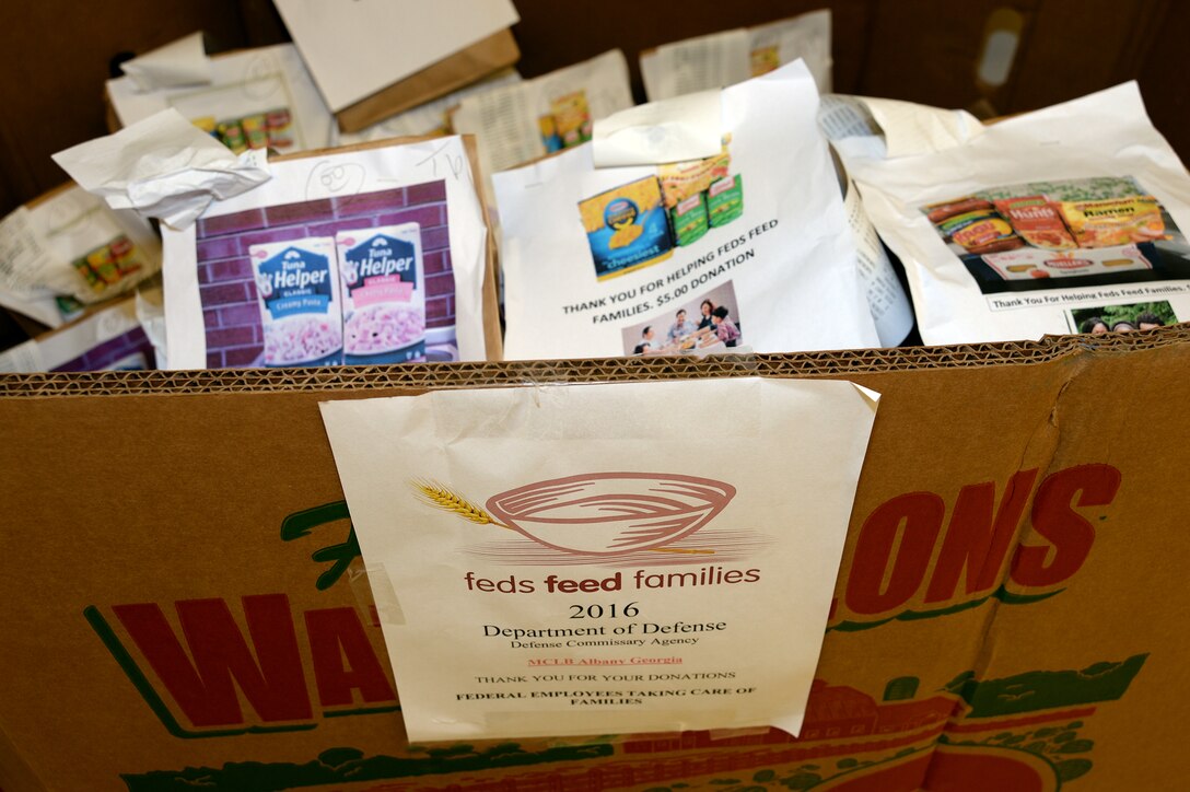 Marine Corps Logistics Base Albany and Defense Commissary Agency officials are once again teaming up to support the annual “Feds Feed Families” campaign, which is scheduled to end Aug. 31.
William Easter, store manager, MCLB Albany Commissary, said the 2016 “Feds Feed Families” campaign is on track for another successful year.   
“Commissary patrons have an opportunity to purchase pre-made bag of canned goods with products ranging from vegetables and tuna to noodles and soups,” Easter said. “We have five assorted bags customers can choose from at a cost of $5 per bag.”
Easter added this is his first year being involved in the program that will help needy families off base. 
“It feels great to provide a program such as this one, but it’s the customers -- the active duty and retired military members and their family members -- that come in and make that donation out of their own free will,” he added. “The holidays are coming up, so I believe the food from the campaign with greatly contribute to helping those that don’t have food throughout the holidays. It makes me feel good that we can contribute to the community.”
Only authorized shoppers can purchase the pre-made bags, according to Easter.
The process for patrons to purchase a bag has been made easy. Pre-made bags, with pictures of its contents, are located at each checkout counter.
“Once purchased, the patron can drop off their donation in a bin at the exit before leaving the Commissary,” he said.
Easter said Tan Poulitt, front end supervisor, Commissary, has selected various items from the Commissary’s overstock to fill the bags for purchase.
“She makes it a fun competition for the front-end cashiers to get more involved interacting with the customers,” he said. 
 The donations will be distributed to the Second Harvest Food Bank of South Georgia in Albany, Georgia.
Easter said the MCLB Albany Commissary collected nearly 380 pounds of food, worth about $1,900 during the 2015 campaign.
“We are about ha