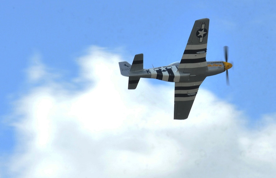 A P-51D Mustang flies over the flightline during the Northern Neighbors Day Air Show at Minot Air Force Base, N.D., Aug. 13, 2016. The P-51 is a well-known fighter aircraft that was often used during World War II. (U.S. Air Force photo/Airman 1st Class Jonathan McElderry)