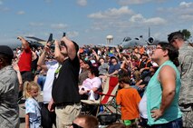 Spectators look towards the sky to view an aero sports performance during the Northern Neighbors Day Air Show at Minot Air Force Base, N.D., Aug. 13, 2016. This was the first Minot AFB air show in seven years. (U.S. Air Force photo/Airman 1st Class Jonathan McElderry)