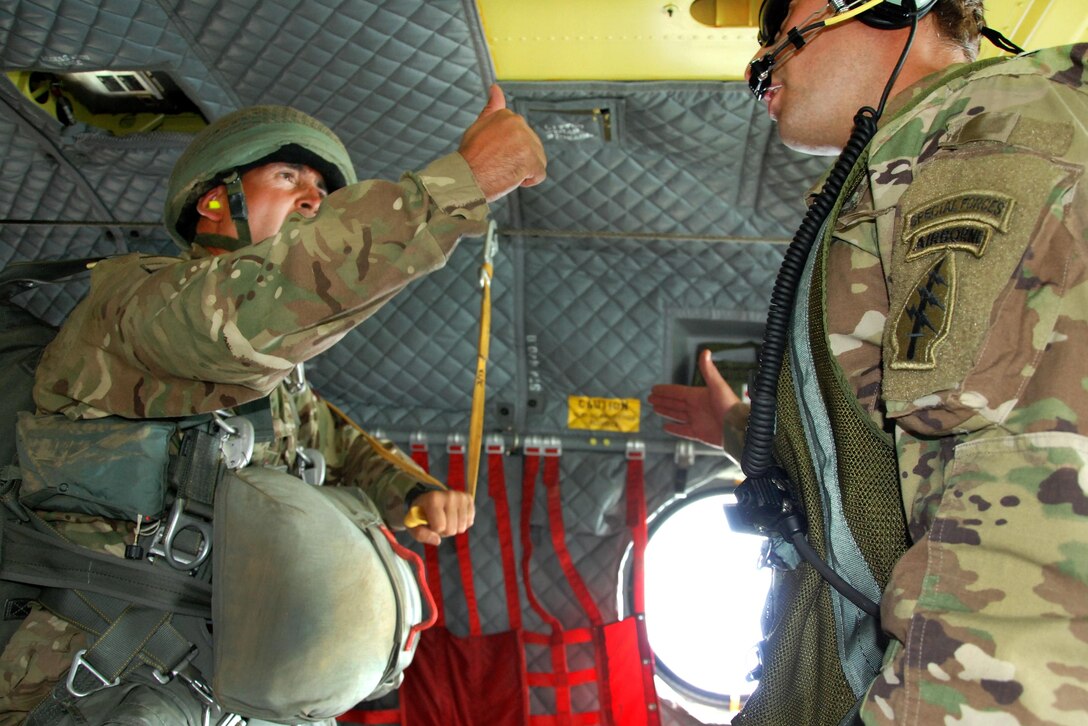 A paratrooper gives the thumbs up before jumping from a CH-47 Chinook helicopter during Leapfest 2016, an international parachute training event, in West Kingston, R.I., Aug. 6, 2016. Army National Guard photo by Staff Sgt. Quentin Davis