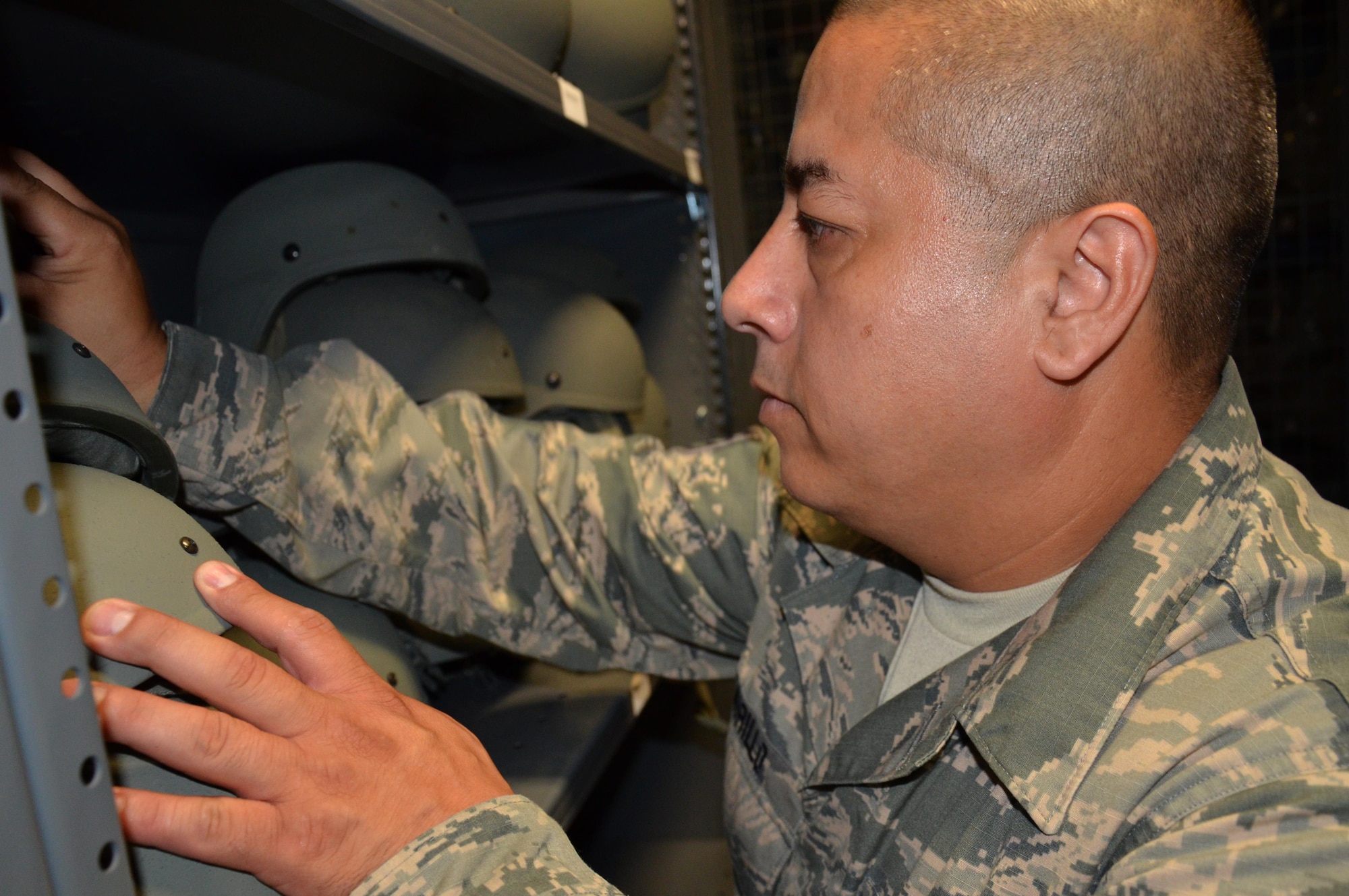 Staff Sgt. Antonio Murillo with the 920th Logistics Readiness Flight, Patrick Air Force Base, Florida, organizes helmets and maintains accountability of government equipment. His mission includes supplying 920th Rescue Wing Airmen with mission capable equipment at a moment's notice. (U.S. Air Force photo by Senior Airman Brandon Kalloo Sanes/Released) 