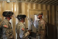 FORT MCCOY, Wis. -- Staff Sgt. Logan Gabrielson (right) from the 603d Military Police Company out of Kansas City, Mo., prepares to open a cell door for a group to suppress an unruly detainee simulated by another Soldier in the unit as part of the Combat Support Training Exercise in Fort McCoy, Wis. on Aug. 14, 2016. CSTX immerses Army Reserve Soldiers and other service members in real-world training scenarios to enhance unit readiness in the planning, preparation, and execution of combat service support operations. (U.S. Army Reserve photo by Spc. Christopher A. Hernandez, 345th Public Affairs Detachment)