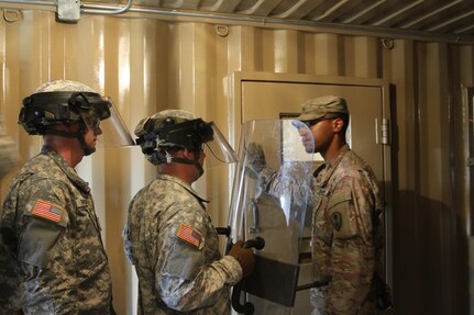 FORT MCCOY, Wis. -- Staff Sgt. Logan Gabrielson (right) from the 603d Military Police Company out of Kansas City, Mo., prepares to open a cell door for a group to suppress an unruly detainee simulated by another Soldier in the unit as part of the Combat Support Training Exercise in Fort McCoy, Wis. on Aug. 14, 2016. CSTX immerses Army Reserve Soldiers and other service members in real-world training scenarios to enhance unit readiness in the planning, preparation, and execution of combat service support operations. (U.S. Army Reserve photo by Spc. Christopher A. Hernandez, 345th Public Affairs Detachment)