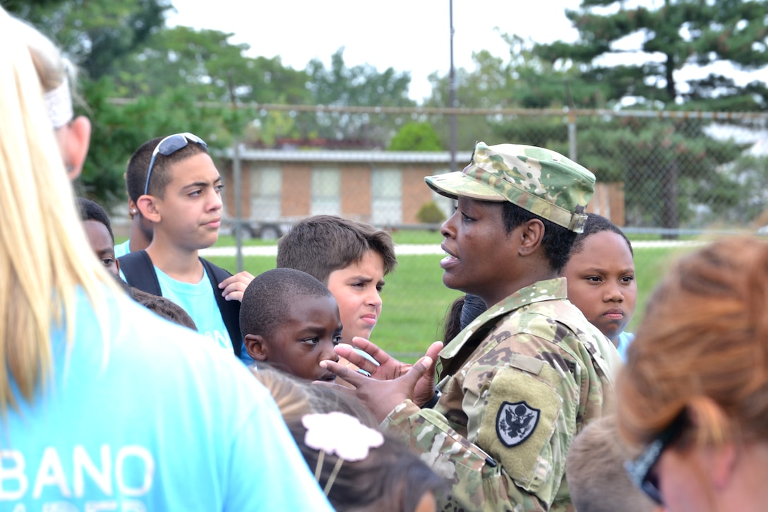 DLA Troop Support C&T Senior Logistician Army Master Sgt. Cynthia Gyening greets campers during the Philly Play Summer Challenge August 10, 2016. DLA Troop Support noncommissioned officers and other local military personnel helped children complete seven obstacle courses during the event. 