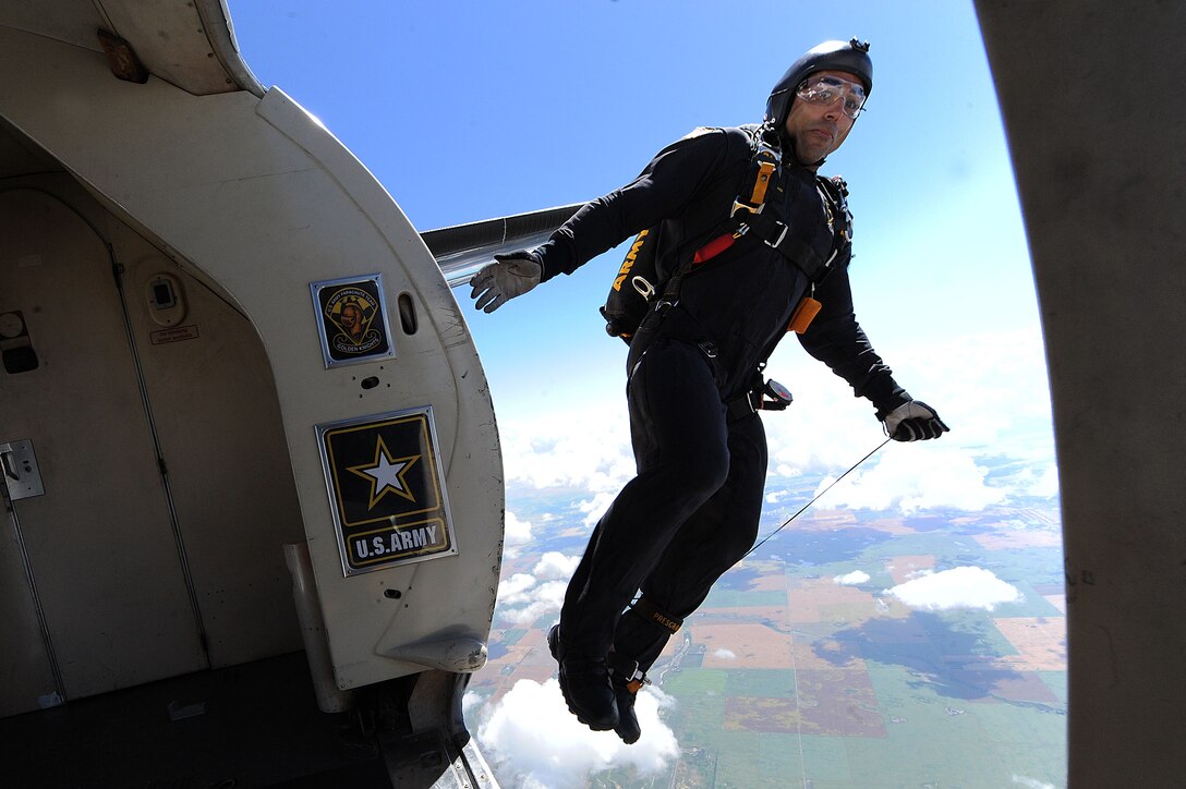 A member of the U.S. Army Golden Knights jumps out of a plane at the Northern Neighbors Day Air Show at Minot Air Force Base, N.D., Aug. 13, 2016. The team performs parachute demonstrations at air shows, major league football and baseball games, and other special events, connecting the Army with the American people. (U.S. Air Force photo/Senior Airman Kristoffer Kaubisch)
