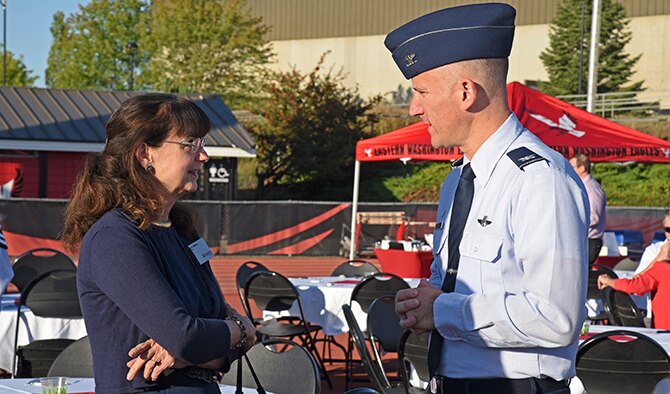 Col. Ryan Samuelson, 92nd Air Refueling Wing commander, discusses the importance of Fairchild Air Force Base’s relationship with the community with Dr. Mary Cullinan, Eastern Washington University president, during the monthly West Plains Chamber of Commerce Breakfast Aug. 17, 2016, in Cheney, Wash. This month’s breakfast was held at EWU’s Roos Field to kick off the Eagles’ upcoming football season. (U.S. Air Force Photo/Airman 1st Class Mackenzie Richardson)