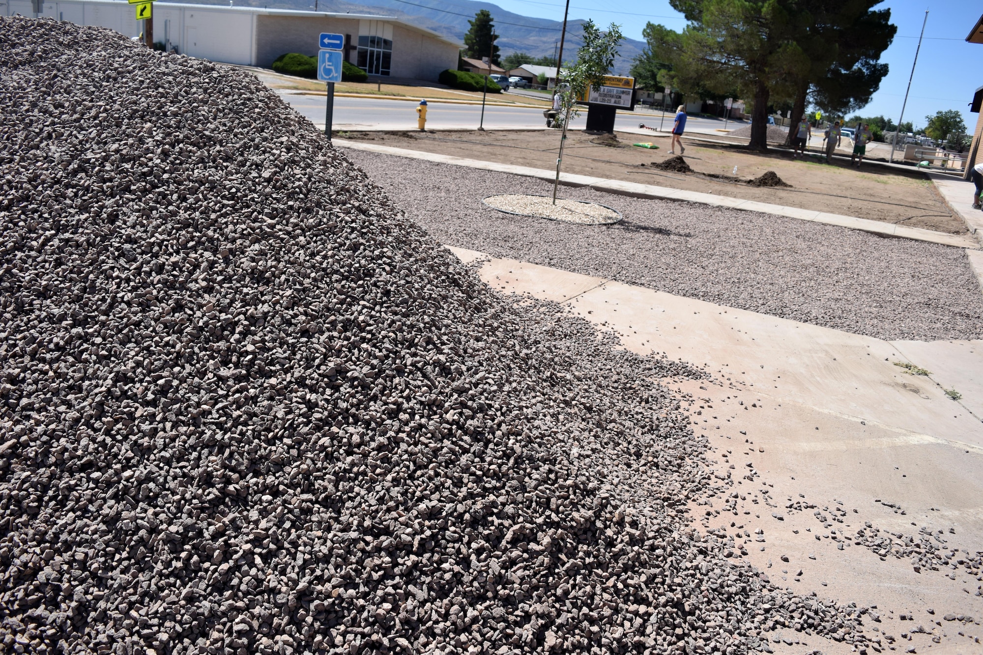 A pile of rock rests near the entrance to Sierra Elementary School in Alamogordo, N.M., on July 23, 2016. More than 77 tons of rock was laid to landscape the entrance area. (U.S. Air Force photo by Staff Sgt. Eboni Prince)