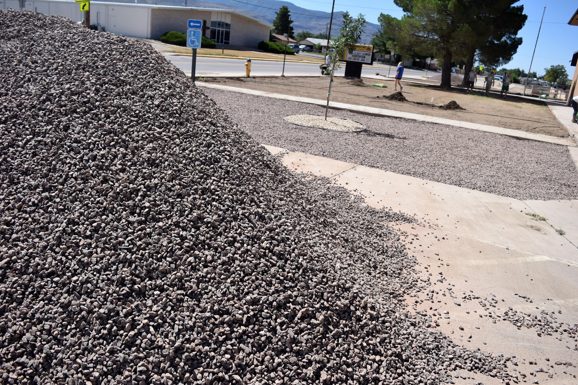 A pile of rock rests near the entrance to Sierra Elementary School in Alamogordo, N.M., on July 23, 2016. More than 77 tons of rock was laid to landscape the entrance area. (U.S. Air Force photo by Staff Sgt. Eboni Prince)