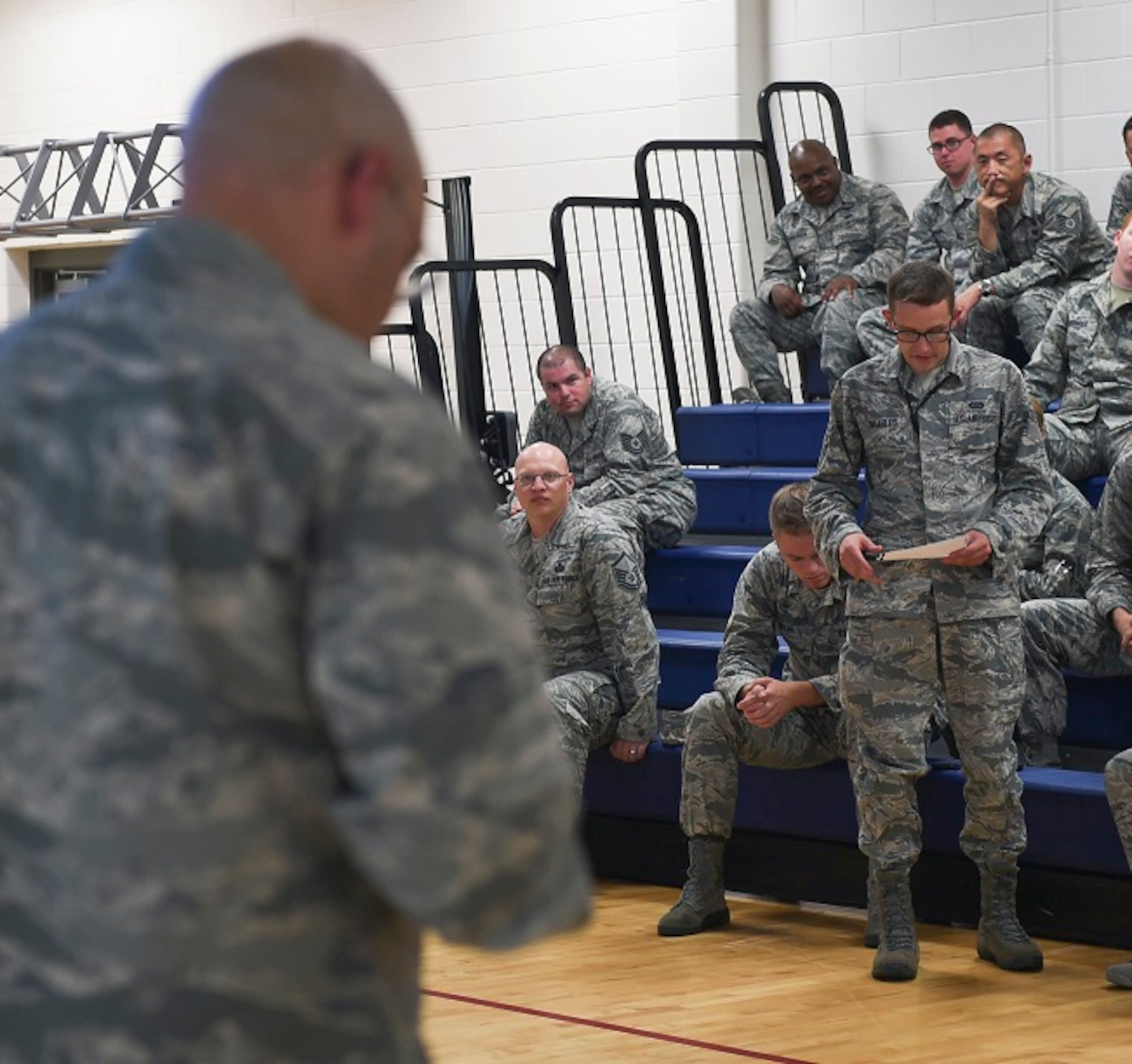 Senior Airman Alex Searless, 460th Operations Group intelligence analyst, asks a question of Col. David Miller Jr., 460th Space Wing commander, during Miller’s first commander’s call at the Buckley Fitness Center Aug. 15, 2016, on Buckley Air Force Base, Colo. During his speech, Miller spoke to members of Team Buckley about his personal life, career experiences, expectations and vision for the base. (U.S. Air Force photo by Airman Holden S. Faul/ Released)