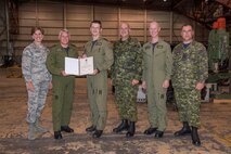 Major-General Christian Drouin (second on left), Commander of 1 Canadian Air Division; General Lori Robinson (left), North American Aerospace Defense Command and U.S. Northern Command Commander; Colonel Paul Doyle, 4 Wing Base Commander; and Warrant Officer Robert Brassington, Acting 4 Wing Chief, presents a commendation to Major Brad Steels, Commanding Officer of 417 Squadron and 417 Squadron Master Warrant Officer Mark Riach, outside Hangar 1, 4 Wing Cold Lake, Alberta, August 15, 2016.