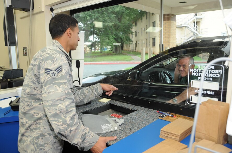 Senior Airman Jesse Charran-Sankar, 2nd Medical Group pharmacy supply custodian, delivers a prescription to a customer through the drive-thru pick-up window at Barksdale Air Force Base, La., Aug. 16, 2016. The pharmacy is open to military members, retirees and their families. (U.S. Air Force photo/Airman 1st Class Stuart Bright)
