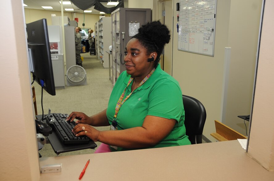 Sakineh Reed, 2nd Medical Group pharmacy technician contractor, works the front window of the Satellite Pharmacy at Barksdale Air Force Base, La., Aug. 16, 2016. The Satellite Pharmacy fills an average of 5,000 prescriptions a week. (U.S. Air Force photo/Airman 1st Class Stuart Bright)